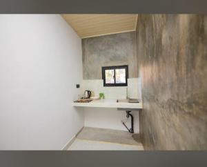 a small bathroom with a sink and a window at City Villa Dikwella in Dickwella +14 photos