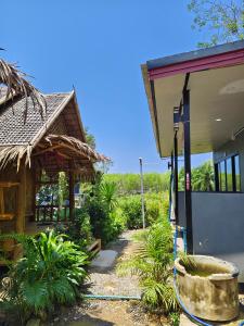 a house with a water hose coming out of it at Fa eap Bungalow in Ko Lanta Yai