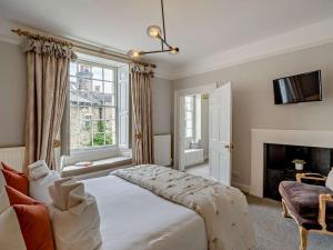 a bedroom with a bed and a fireplace at 4 Bed in Middleham oc-g0189 in Middleham