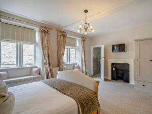 a large bedroom with a bed and a fireplace at 4 Bed in Middleham oc-g0189 in Middleham