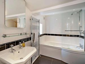 a bathroom with a tub and a sink and a shower at 4 Bed in Middleham oc-g0189 in Middleham +29 photos