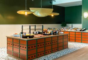 a kitchen with a counter with food on it at B&B HOTEL Geneva Airport in Geneva