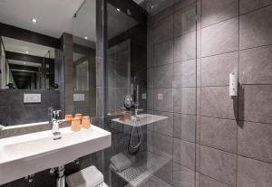 a bathroom with two sinks and a mirror at B&B HOTEL Geneva Airport in Geneva