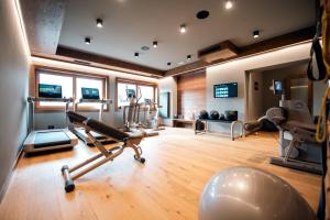 a gym with a treadmill and exercise equipment in a room at Casa Guargnè in Cortina dʼAmpezzo