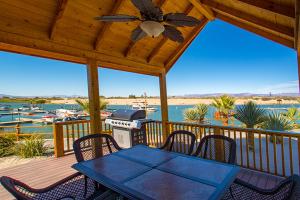 a patio with a table and chairs on a deck at Pirate Cove Resort in Needles
