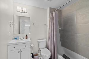 a bathroom with a toilet and a sink and a shower at Entire DC House 3BR 3BA RoofDeck Free Parking Near Capitol Hill in Washington, D.C. +9 photos