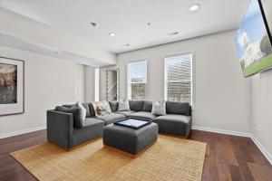 a living room with a couch and a table at Entire DC House 3BR 3BA RoofDeck Free Parking Near Capitol Hill in Washington, D.C.