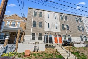 an apartment building with orange doors on a street at Entire DC House 3BR 3BA RoofDeck Free Parking Near Capitol Hill in Washington, D.C.