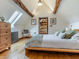 a bedroom with a large bed and a wooden dresser at 2 Bed in Broadway oc-62262 in Broadway