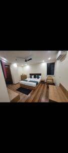 a living room with two beds and a flat screen tv at Hotel GS GRAND in Dehradun