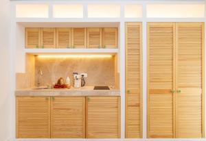 a kitchen with wooden cabinets and a sink at Aria di Mare CENTER HOME in Vieste