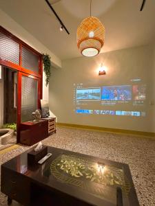 a living room with a tv and a large screen at 光陰GUANGinn in Hsinchu City +35 photos
