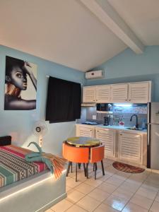 a kitchen with a table and a dining room at Studio Lipstick in Saly Portudal