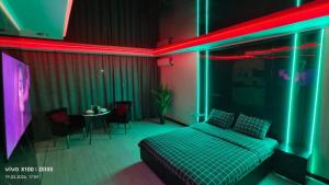 a room with a bed and a table with chairs at Астана 34 in Ustʼ-Kamenogorsk