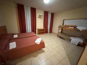 a hotel room with a bed and a couch at Hotelleria di Ovada in Ovada