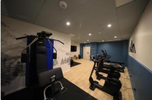 a gym with several exercise bikes in a room at Arc 1950 Ski in Ski out and Spa- Newly refurbished 153 Sources De Marie- 2 bedroom , 2 bathroom-Sleeps 4-6, Mont Blanc view from every window, Free WiFi in Arc 1950