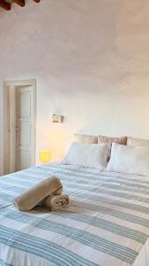 a bed with a towel laying on top of it at Captains Garden House in Katavatí