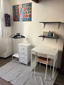 a white desk with a chair and a dresser at Casa sulla spiaggia in Genoa +26 photos