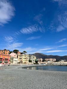 a group of buildings on a beach next to the water at Casa sulla spiaggia in Genoa
