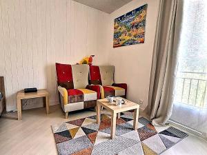 a living room with a chair and a table at 5 Mins to Train Station - Free Parking - DisneyLand - Escapade Perchée in Pomponne