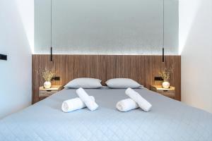 a bedroom with a bed with three pillows on it at Elysian Studio A4 in Karpathos