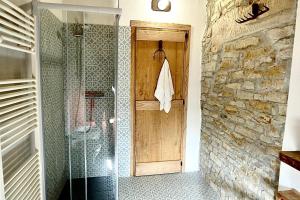 a bathroom with a shower and a glass shower stall at BeB La Bergera in Cessole +2 photos