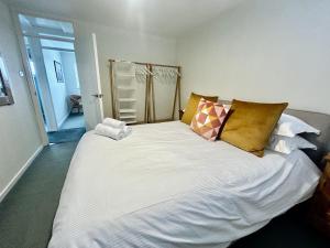 a large white bed with pillows in a room at 16 Manesty View in Keswick