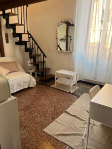 a room with a bed and a staircase with a mirror at Casa sulla spiaggia in Genoa