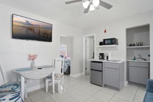 a kitchen with a table and a counter top at Blind Pass Resort Motel in St. Pete Beach