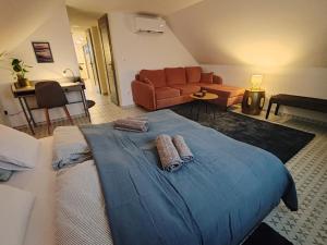 a large bed in a living room with a couch at MANSARD - Bozsok in Bozsok