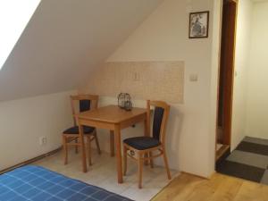 a dining room with a table and two chairs at carpedieme in Horní Brusnice