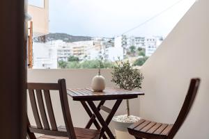 a small table and two chairs on a balcony at Elysian Studio A4 in Karpathos