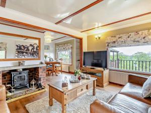 a living room with a couch and a fireplace at 2 Bed in Leek oc-52923 in Grindon