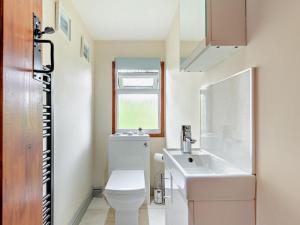 a bathroom with a white toilet and a sink at 2 Bed in Leek oc-52923 in Grindon +17 photos