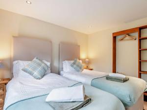 two beds sitting next to each other in a room at 2 Bed in Leek oc-52923 in Grindon