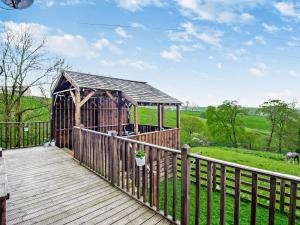 a wooden deck with a gazebo in a field at 2 Bed in Leek oc-52923 in Grindon