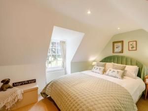 a bedroom with a large bed with a green headboard at 3 Bed in Duns oc-89133 in Swinton