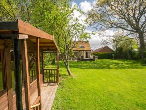 a wooden deck with a house in a yard at 2 Bed in Wareham oc-dc184 in Stoborough
