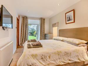a bedroom with a large bed and a window at 2 Bed in Wareham oc-dc184 in Stoborough