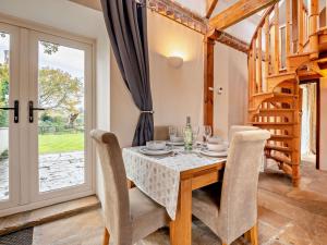 a dining room with a table and chairs and a window at 2 Bed in Wareham oc-dc184 in Stoborough