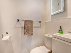 a white bathroom with a toilet and a sink at 2 Bed in Wareham oc-dc184 in Stoborough +20 photos