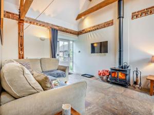 a living room with a couch and a wood stove at 2 Bed in Wareham oc-dc184 in Stoborough