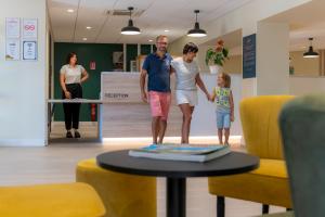 a man and a woman standing next to a table at VTF Village de vacances Le Domaine d'Agde in Agde