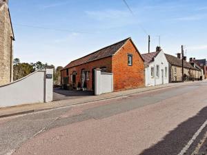 an empty street with a brick building on the side at 2 Bed in Malmesbury oc-91453 in Malmesbury