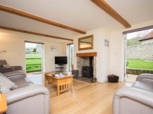 a living room with two couches and a fireplace at 3 Bed in Wareham oc-dc137 in West Lulworth