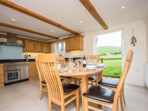a kitchen with a wooden dining table and chairs at 3 Bed in Wareham oc-dc137 in West Lulworth