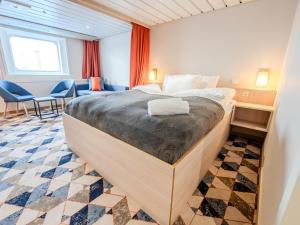 a bedroom with a large bed in a room at DFDS Ferry - Newcastle to Amsterdam in Newcastle upon Tyne