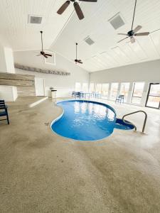 a swimming pool in a room with blue water at The Little Penthouse in Lake Ozark
