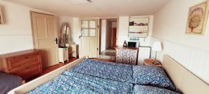 a bedroom with a bed with a blue comforter at Farma U Nýdrlů in Stará Červená Voda +60 photos