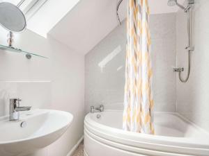 a bathroom with a sink and a tub and a toilet at 4 Bed in Worcester oc-77991 in Clifton upon Teme +25 photos